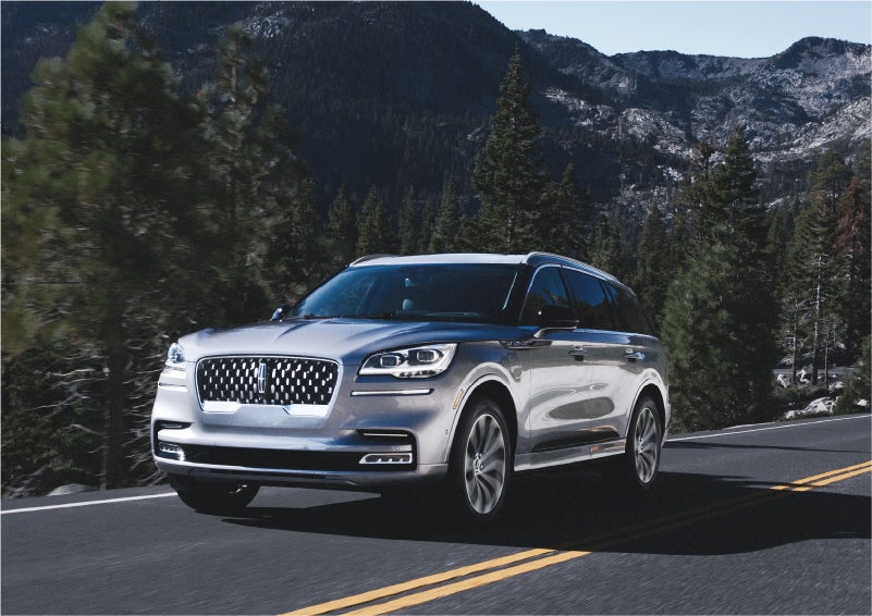 A 2023 Lincoln Aviator® Grand Touring SUV being driven on a winding road to demonstrate the capabilities of all-wheel drive | Beach Lincoln in Myrtle Beach SC