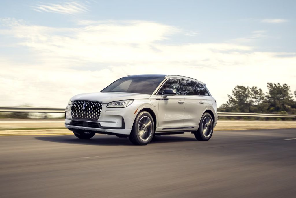 white lincoln corsair driving on the road