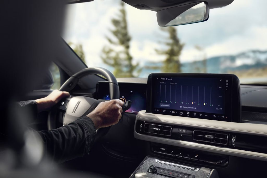 Shoulder down view of male driver grasping the steering wheel of 2026 Lincoln Aviator