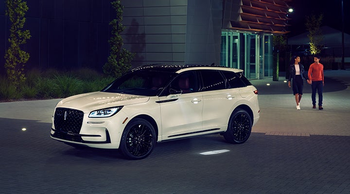 Two people approach a 2024 Lincoln Corsair® SUV featuring the available Jet Appearance Package. | Beach Lincoln in Myrtle Beach SC