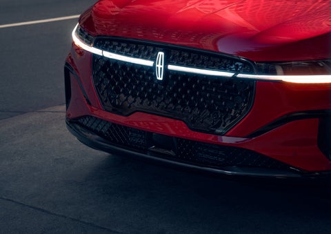The available front LED light bar and center Lincoln Star logo glow at dusk. | Beach Lincoln in Myrtle Beach SC
