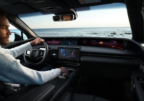 A driver of a parked 2025 Lincoln Nautilus® SUV takes a relaxing moment at a seaside overlook while inside his Nautilus. | Beach Lincoln in Myrtle Beach SC