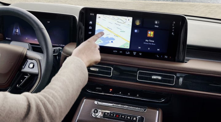 A person is tapping the center display touchscreen of a 2026 Lincoln Aviator® SUV. | Beach Lincoln in Myrtle Beach SC