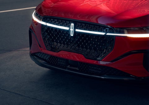 The available front LED light bar and center Lincoln Star logo glow at dusk. | Beach Lincoln in Myrtle Beach SC