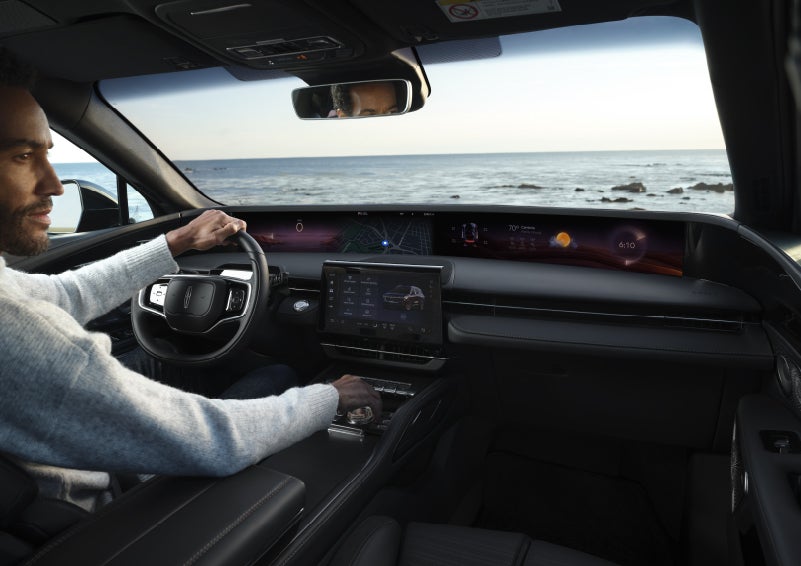 A driver of a parked 2026 Lincoln Nautilus® SUV takes a relaxing moment at a seaside overlook while inside his Nautilus. | Beach Lincoln in Myrtle Beach SC
