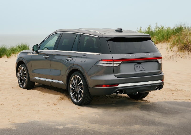 A 2027 Lincoln Aviator® SUV is parked next to sand dunes. | Beach Lincoln in Myrtle Beach SC