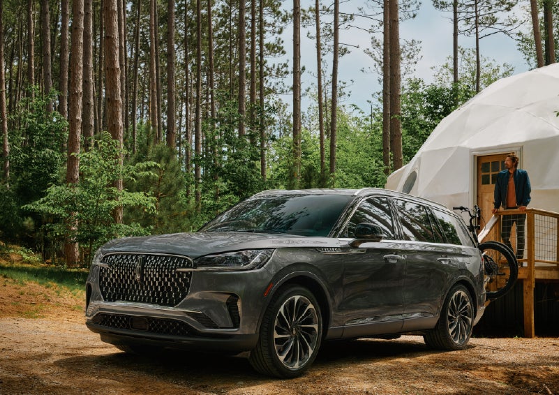 A 2027 Lincoln Aviator® is parked next to a high end glamping site. | Beach Lincoln in Myrtle Beach SC