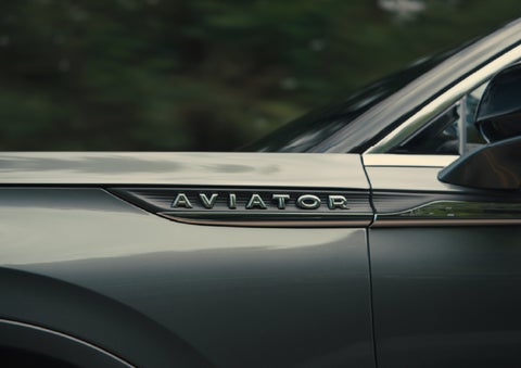 The driver’s side door and fender badging of a gray 2027 Lincoln Aviator® SUV are showcased. | Beach Lincoln in Myrtle Beach SC