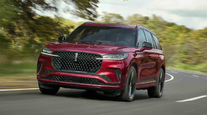 A 2027 Lincoln Aviator® SUV is being driven on a country road | Beach Lincoln in Myrtle Beach SC