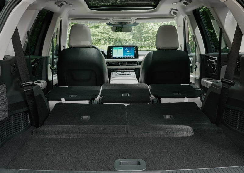 A rear to front view of the interior of a 2027 Lincoln Aviator® Black Label™ SUV shows the third and second rows folded flat | Beach Lincoln in Myrtle Beach SC