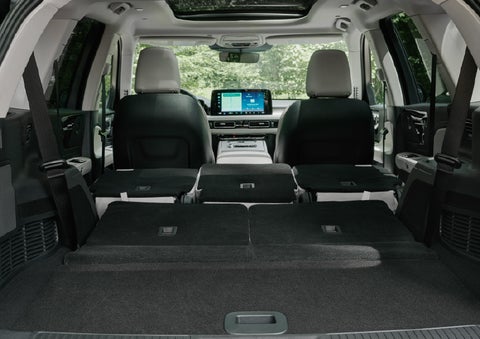 A rear to front view of the interior of a 2027 Lincoln Aviator® Black Label™ SUV shows the third and second rows folded flat | Beach Lincoln in Myrtle Beach SC