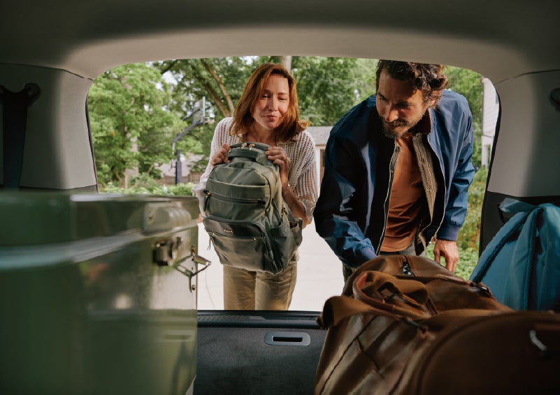A couple loads luggage into the rear of a 2027 Lincoln Aviator® Black Label™ SUV..e 202 | Beach Lincoln in Myrtle Beach SC